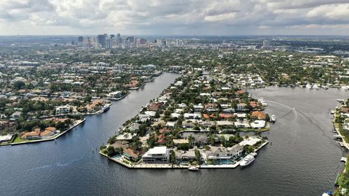 High angle view of buildings by sea against sky