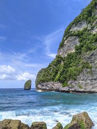 Scenic view of rocks in sea against sky