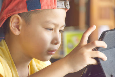 Close-up portrait of boy using mobile phone