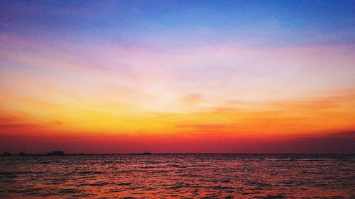 Scenic view of sea against romantic sky at sunset