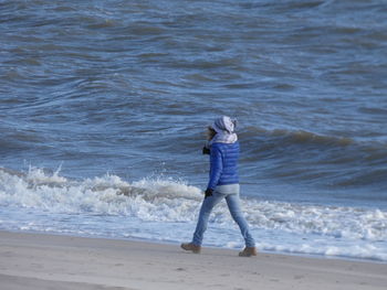 Full length of woman standing on beach