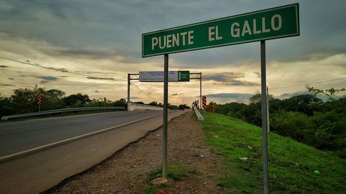Road sign against sky