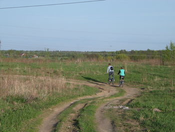 Full length of woman walking on dirt road