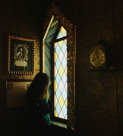 Woman standing against window