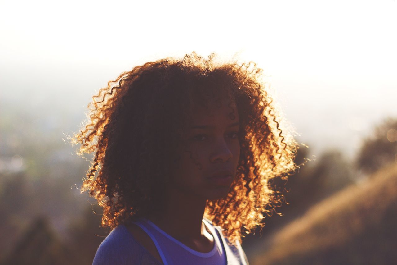 lifestyles, leisure activity, headshot, rear view, person, focus on foreground, sky, long hair, men, close-up, head and shoulders, outdoors, brown hair, unrecognizable person, standing, nature, human hair