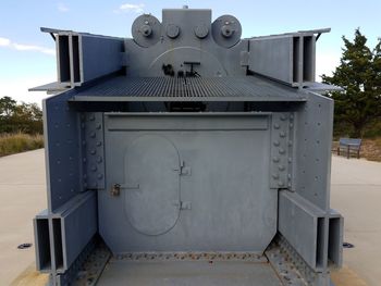 Close-up of machine part against sky