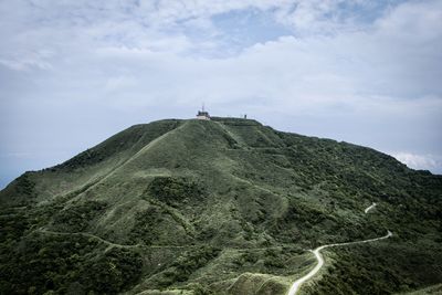 Scenic view of cross on mountain against sky