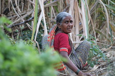 Woman looking away while standing on land