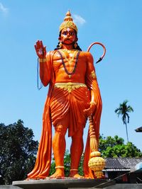 Low angle view of hanuman statue against sky