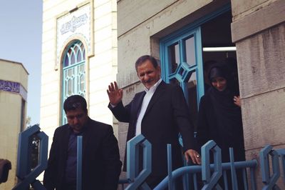 Men standing in front of building