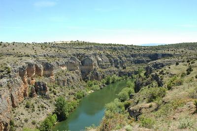 View of rock formations on landscape against sky