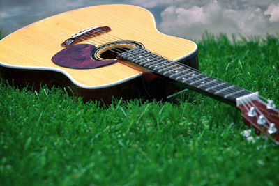 Close-up of guitar on field