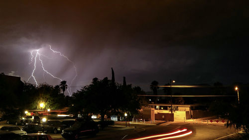 Panoramic view of lightning over city at night