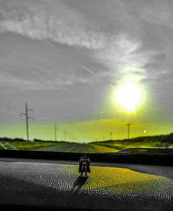 Close-up of yellow car on road against sky