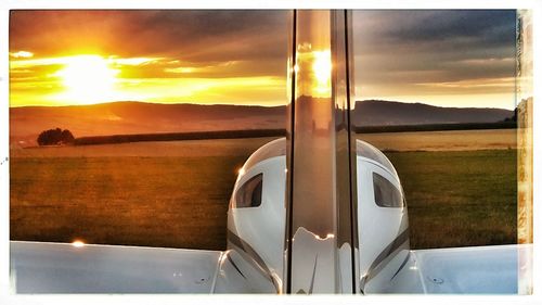 Close-up of airplane against sky at sunset