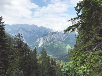 Scenic view of mountains against cloudy sky