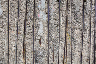 Close-up of metal rod on weathered wall