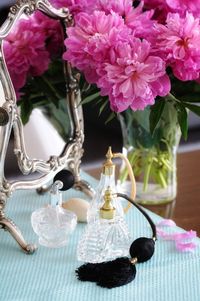 Close-up of pink flowers in glass vase on table