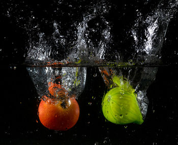 Close-up of wet glass against black background