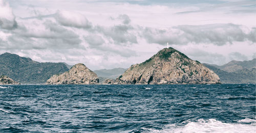 Panoramic view of sea and mountains against sky