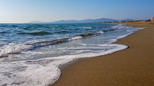 Scenic view of beach against clear sky