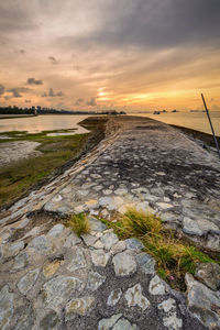 Scenic view of footpath against sky during sunset