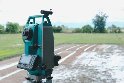 Close-up of camera on field against sky