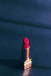 Close-up of red lipstick on table