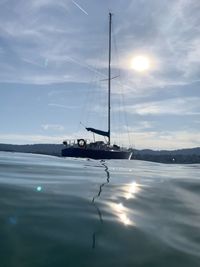 Sailboat in sea against sky