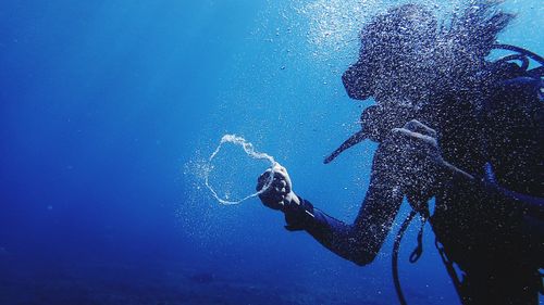 Low angle view of man swimming in sea