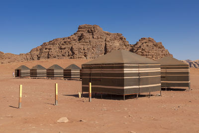 Built structure on desert against clear blue sky