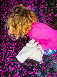 Girl picking pink flowers