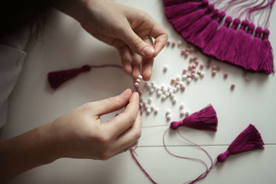 Craftswoman makes brushes from threads. concept creativity, toning in real interior, inspiring