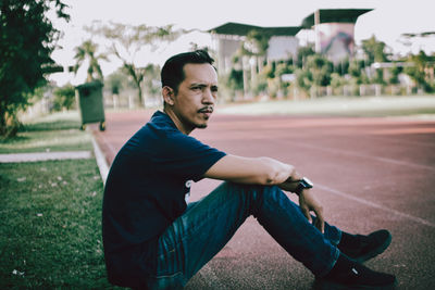 Portrait of young man sitting outdoors