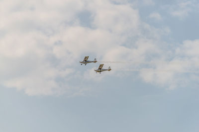 Low angle view of airshow against sky