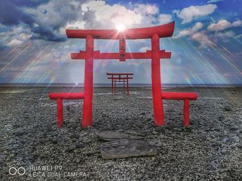 Red chairs against sky