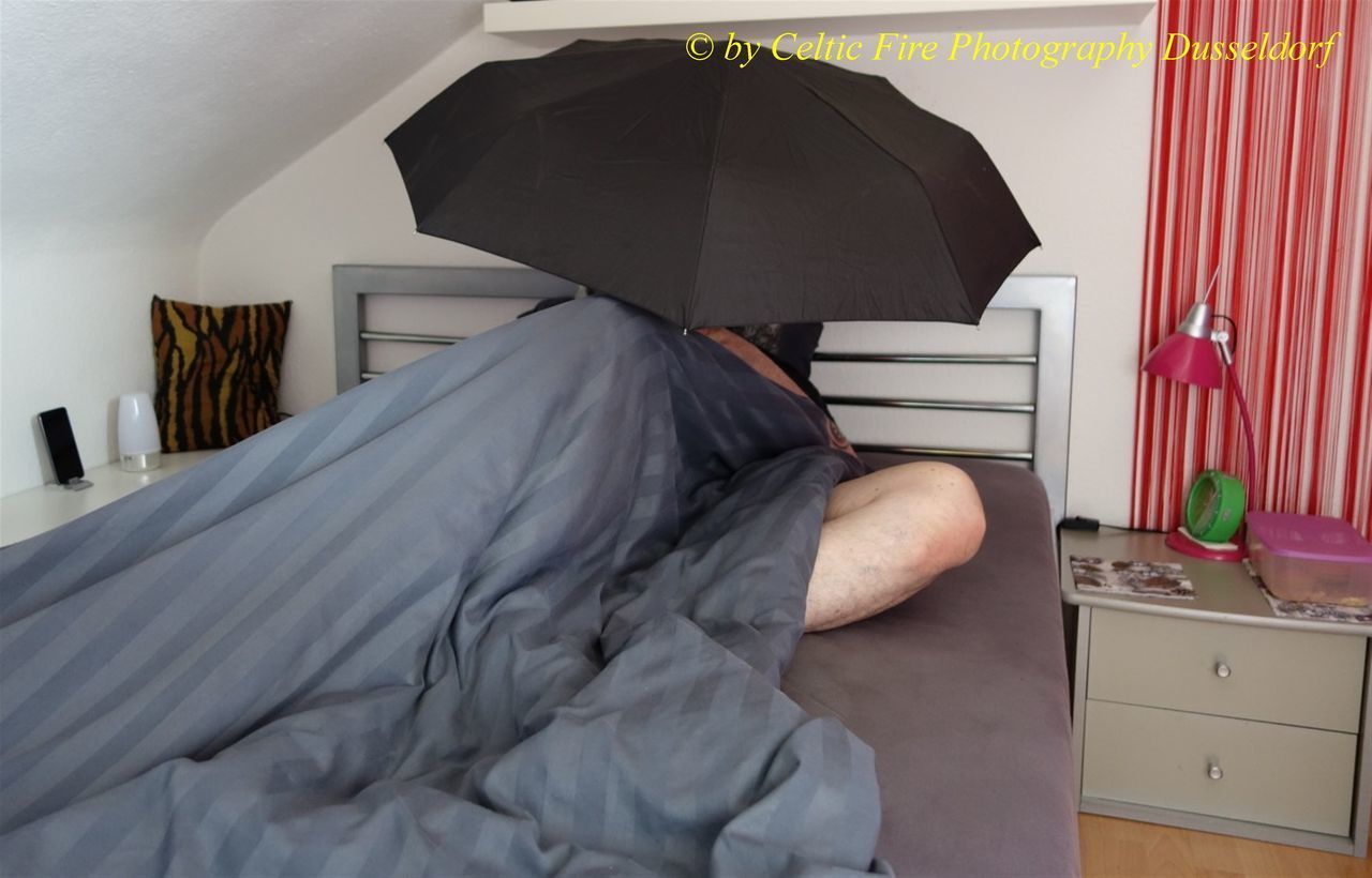 REAR VIEW OF WOMAN LYING ON BED