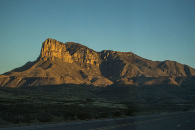 Scenic view of mountains against clear blue sky