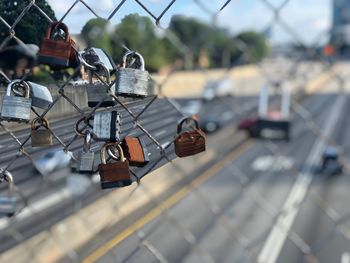 Close-up of padlocks on chainlink fence