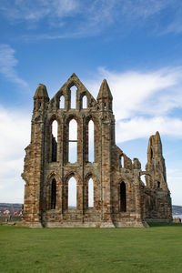 Whitby abbey against cloudy sky