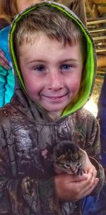 Portrait of smiling boy with cat