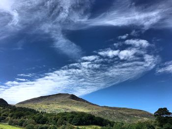 Low angle view of mountain against blue sky