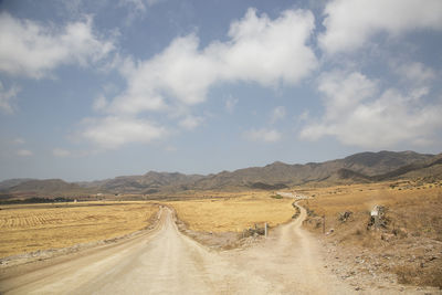 Empty road along countryside landscape