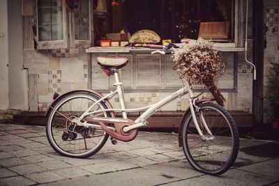 Bicycle parked on street by building