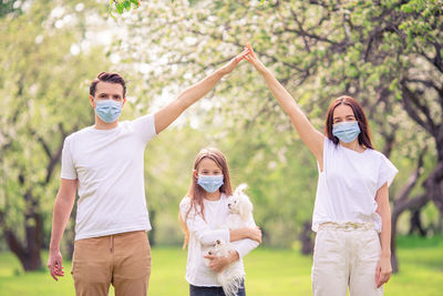 Portrait of family wearing mask outdoors