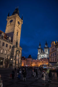 Group of people in front of buildings in city