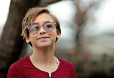 Close-up portrait of smiling girl wearing sunglasses