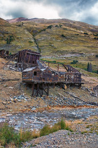 Abandoned built structure on land against sky