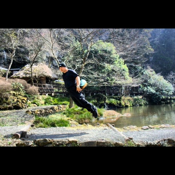 lifestyles, full length, leisure activity, tree, water, standing, casual clothing, side view, young adult, forest, nature, rear view, river, lake, motion, person, jumping, auto post production filter