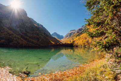 Scenic view of lake and mountains against sky